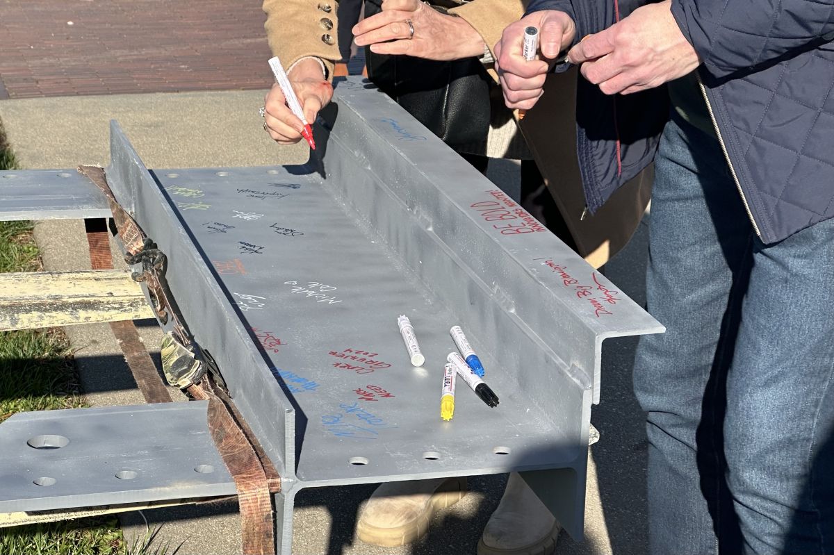 The final steel beam being signed at The Forge