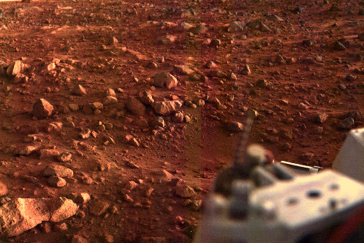 The red soil of Mars. Some gray equipment in the right foreground.