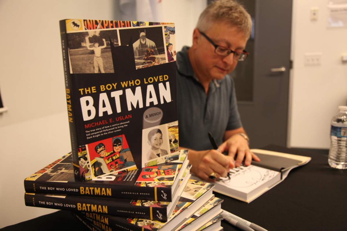 Michael Uslan signing copies of his book, The Boy Who Loved Batman.