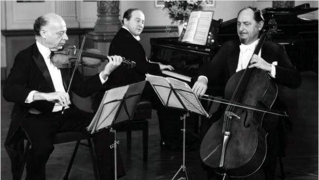 A trio of violin, cello and piano perform.