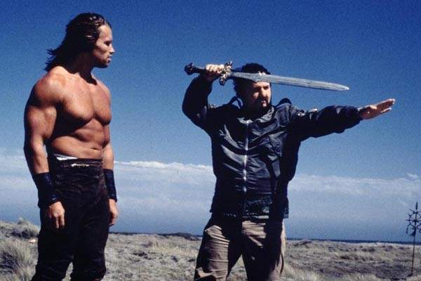 John Milius, subject of the documentary Milius, directing Arnold Schwarzenegger in Conan The Barbarian
