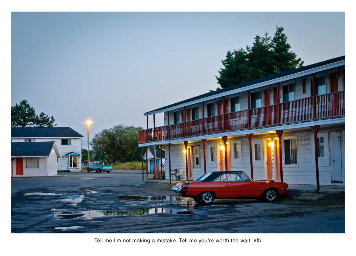 motel at dusk, red car in foreground