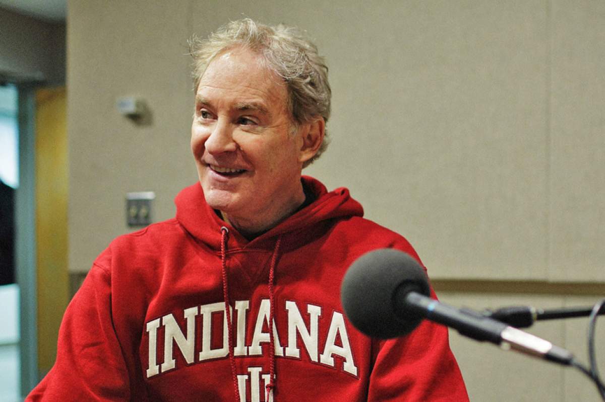 Kevin Kline in WFIU's Studio 3 during his interview with Jon Vickers, wearing red Indiana University hoodie sweatshirt, smiling