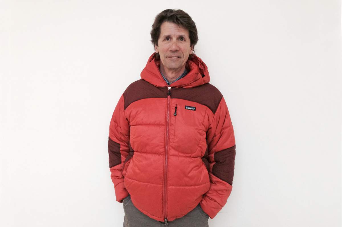 James Balog with hands in pants pockets, wearing zipped-up red parka