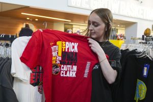 AP - Shelby Tekulve, 20, displays one of the Caitlin Clark shirts she was purchasing in the Indiana Fever team store in Indianapolis, Tuesday, April 16, 2024. The Fever selected Clark as the No. 1 overall pick in the WNBA basketball draft.