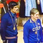 Mark Spitz (l) receives a gold medal on the podium at the 1972 Olympics.