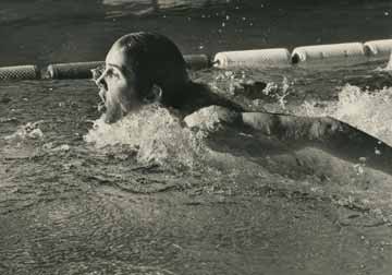 A water-level shot, taken from the side, of Gary Hall coming up for a breath as he swims down the lane.