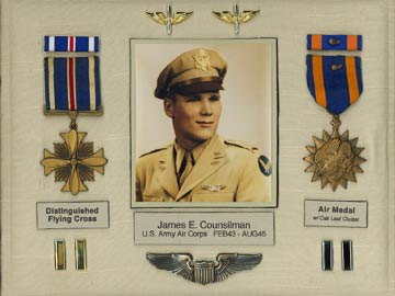 A display of Counsilman's service insignia and medals, including the Distinguished Flying Cross and Air Medal with Oak Leaf Cluster.