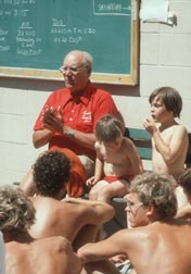 Doc talks to chidren at one of his summer swimming camps.