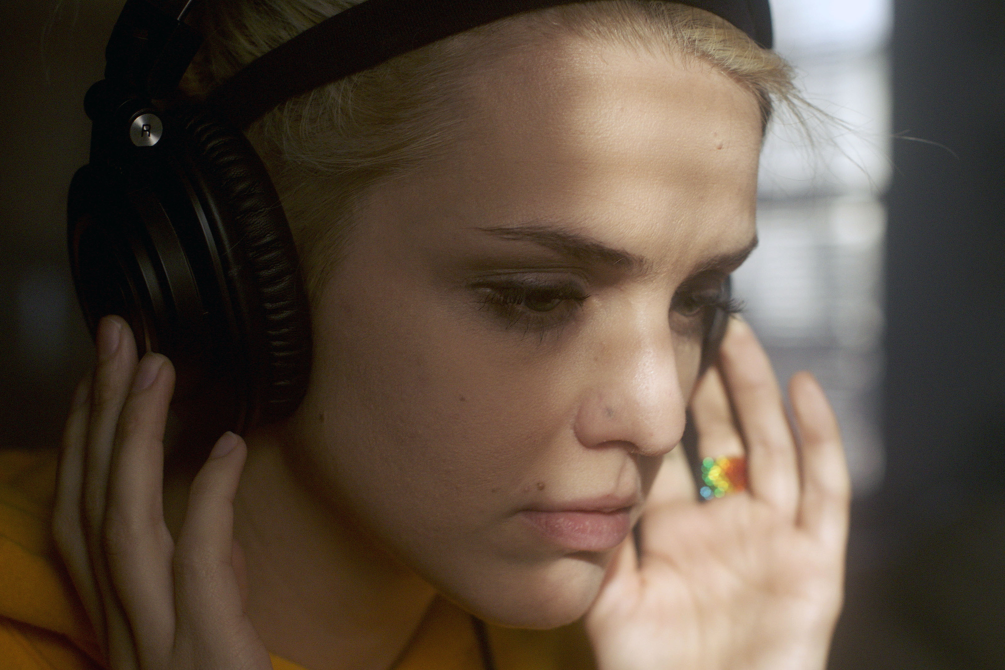 Actress Emily Sweet listens to music in the film Palace (Photo courtesy of One County Film Company)