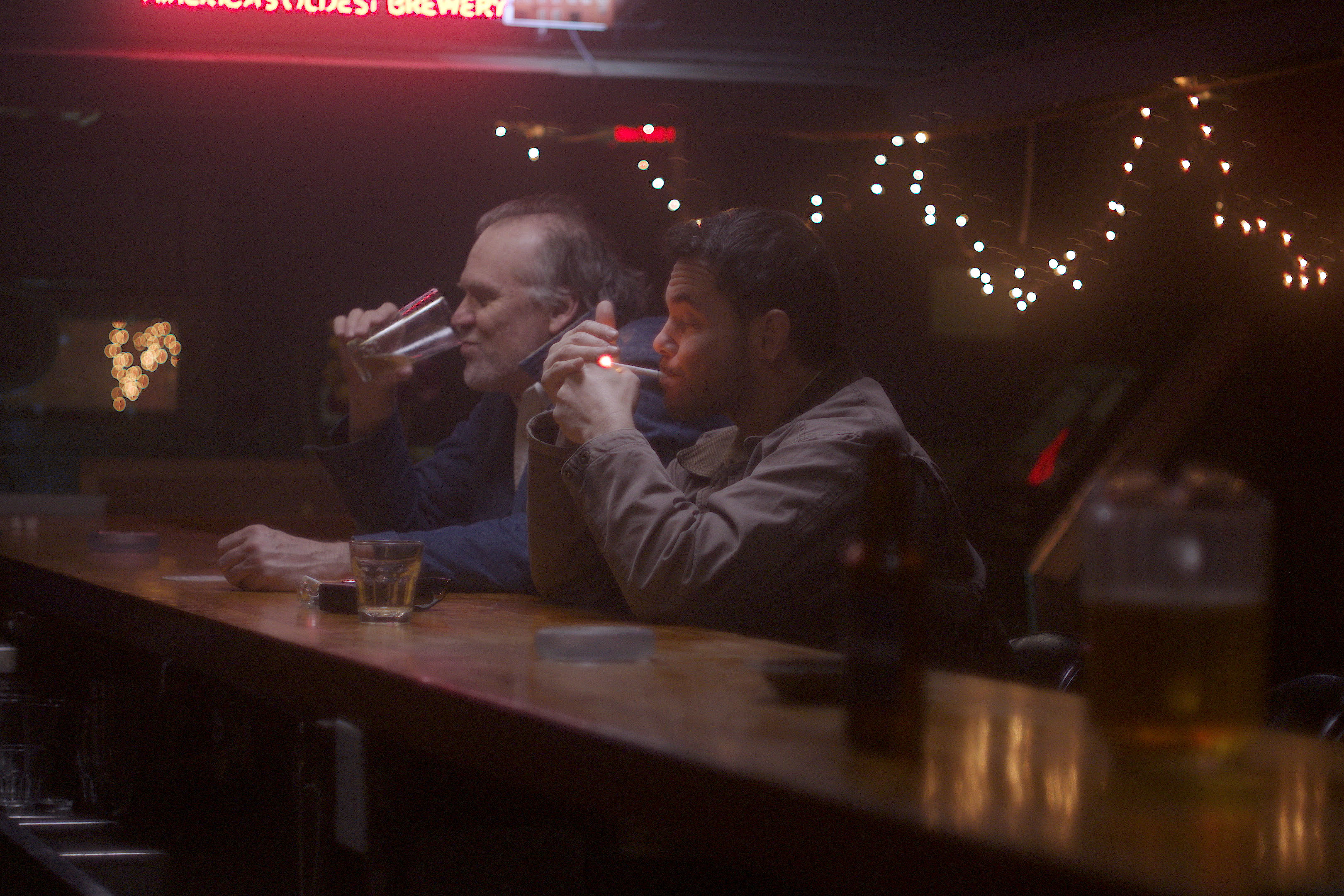 Actors Todd Bruno and Joe Martyn Ricke share a drink in the film Palace. (Photo courtesy of One County Film Company)