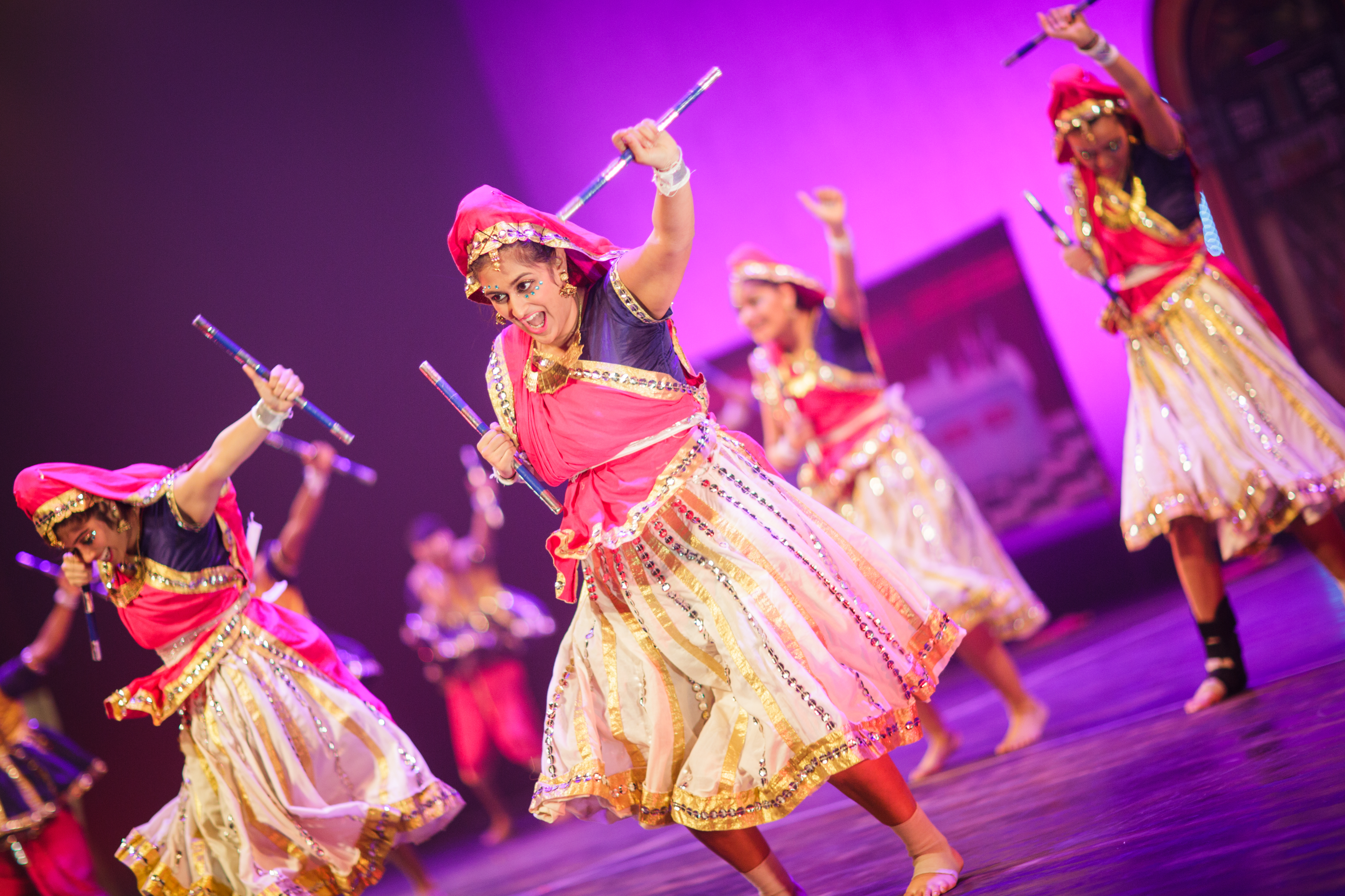 A performer dances with dandiya, sticks used for percussion, during a garba-raas performance. (Photo: Praneeth Gogineni)