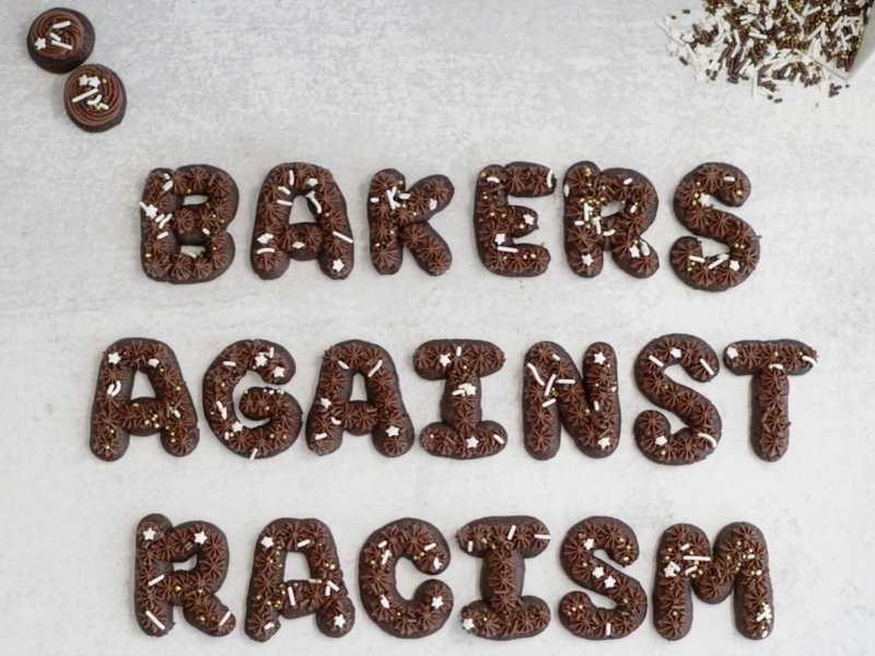 The words 'bakers against racism' spelled out in chocolate cookies with frosting and white sprinkles