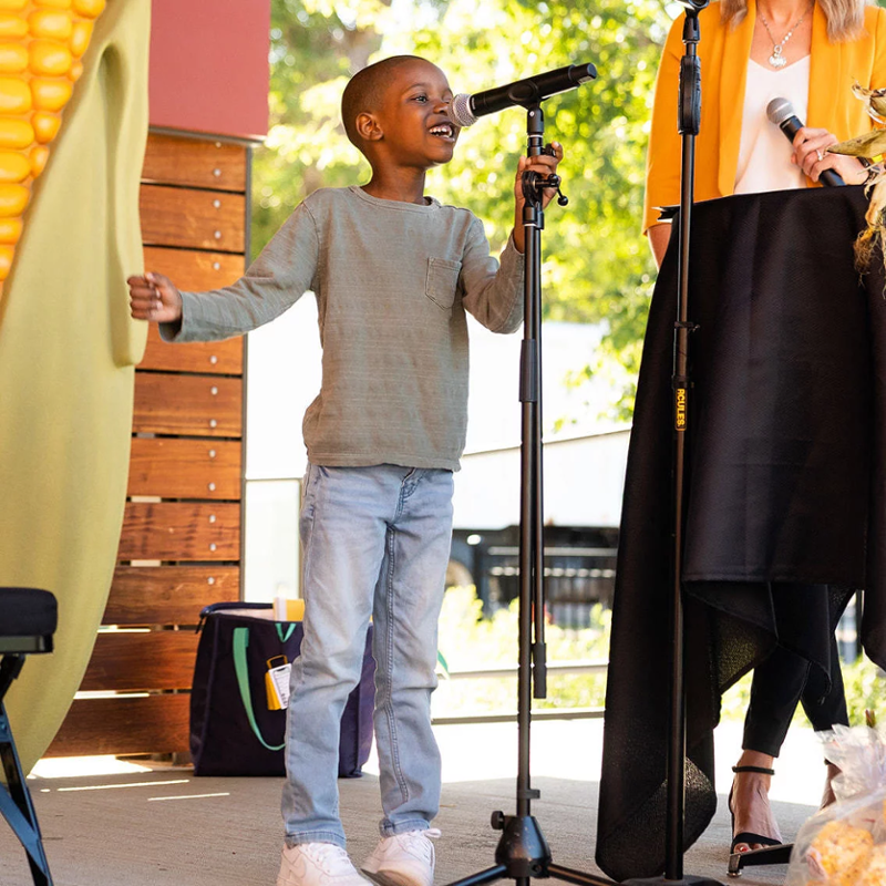 Tariq speaking into a microphone