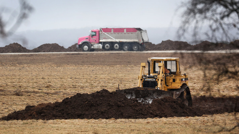 A tractor digging in a field 