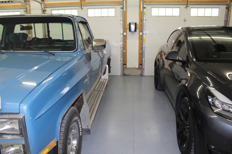 A new Tesla next to a 1984 Chevrolet Silverado