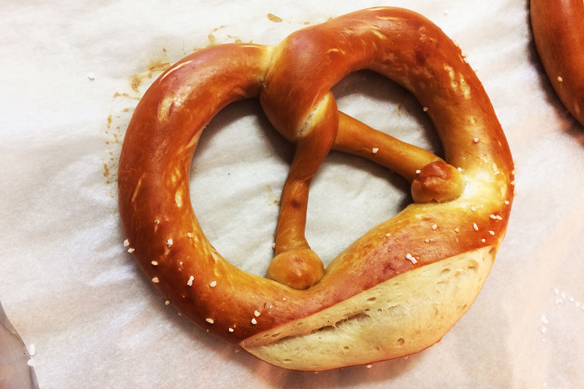 A finished pretzel, baked, golden brown