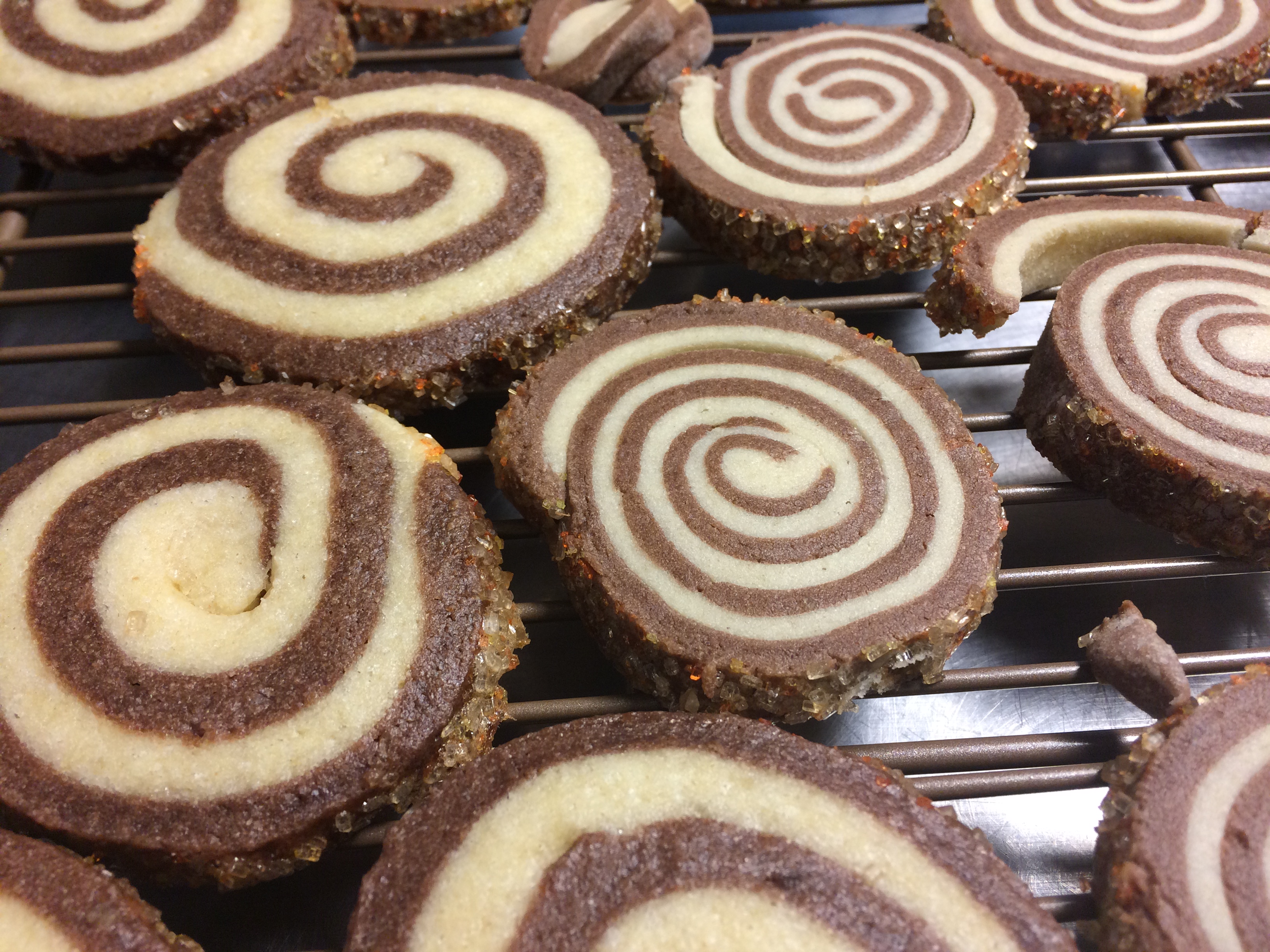 Vanilla chocolate spiral cookies on a cooling rack