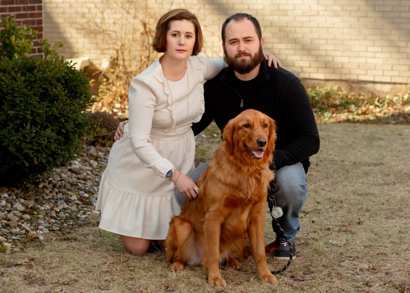 Family posing with their new Golden Retriever Midas