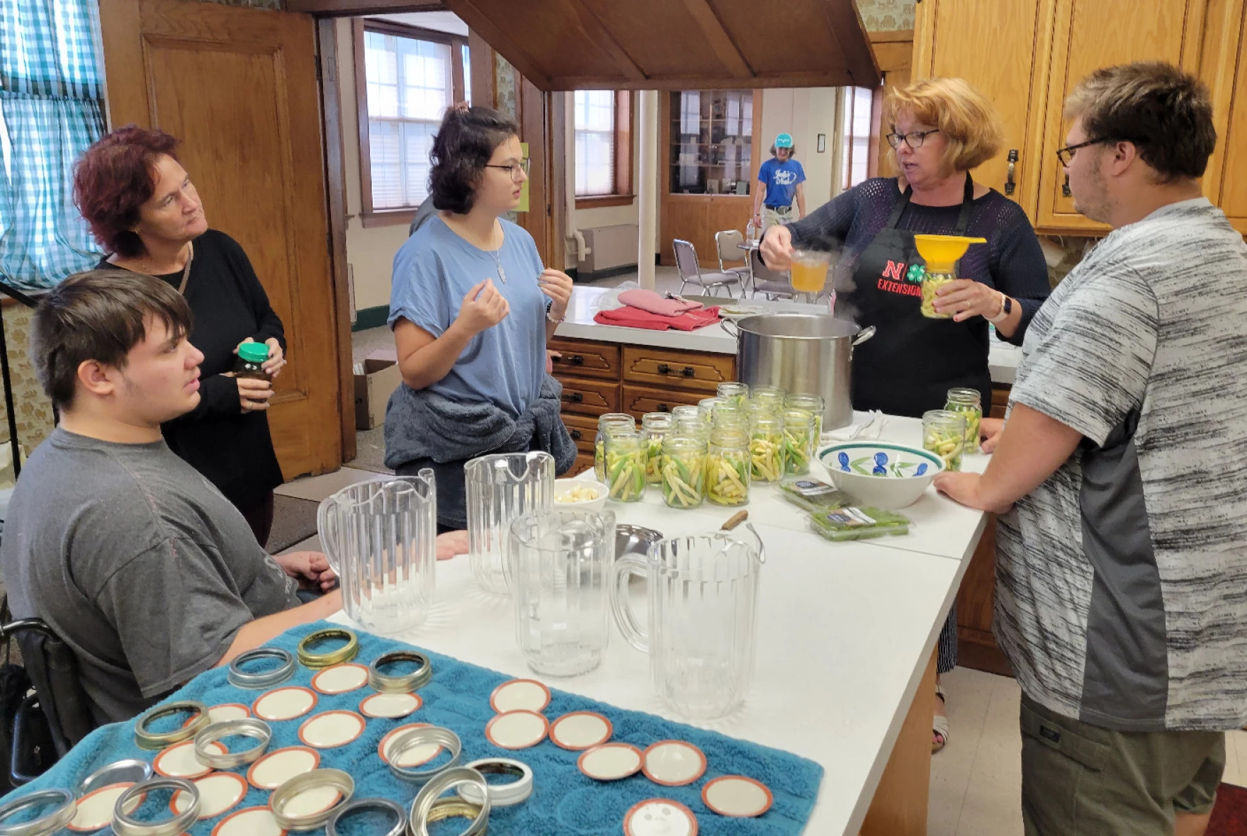 Group of people around a table with cans