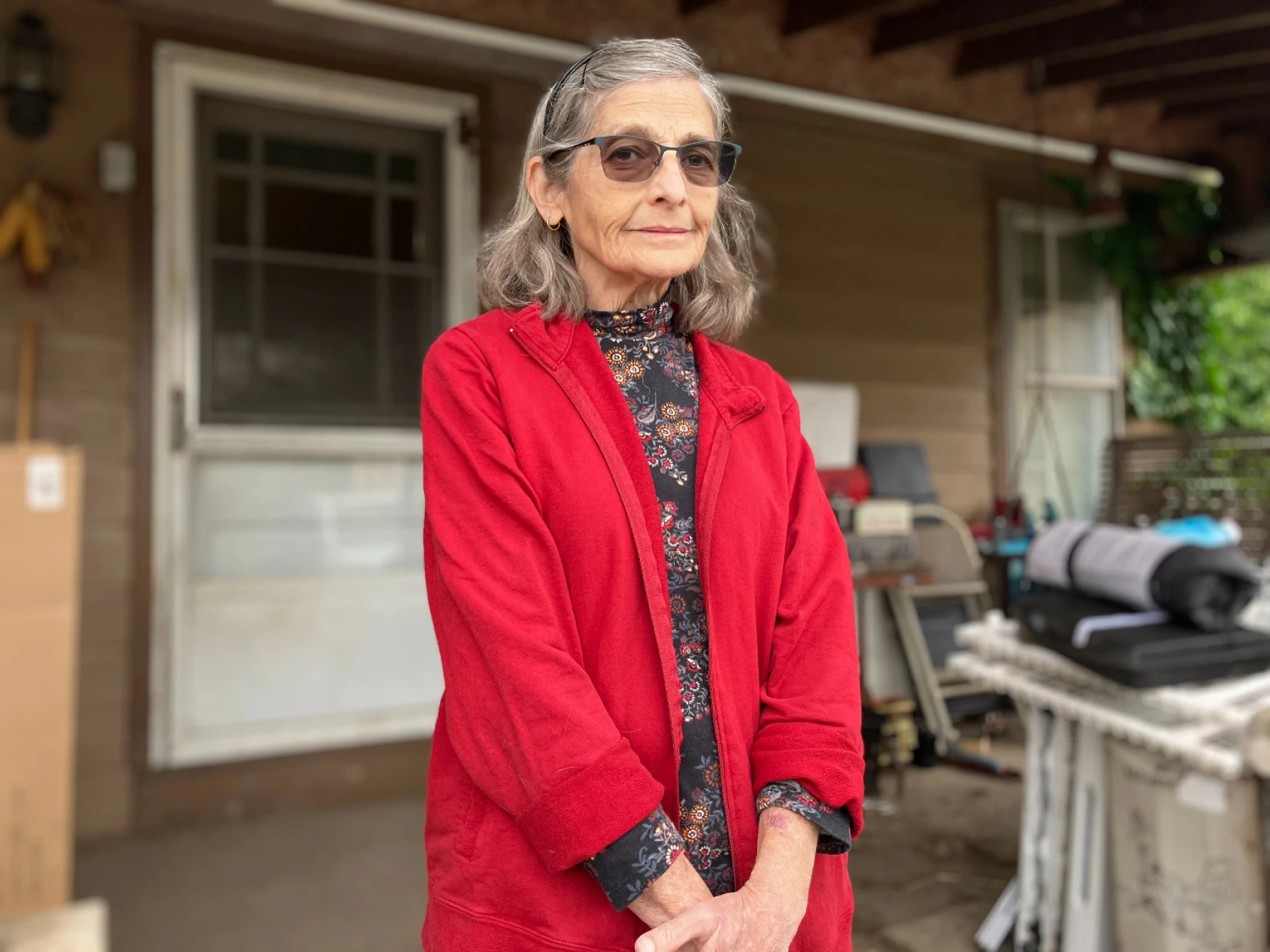 Rebecca Deline standing on a porch to pose for a picture.
