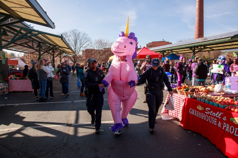 man dressed in inflatable pink unicorn costume