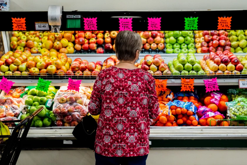 A shopper looking through the produce at a market