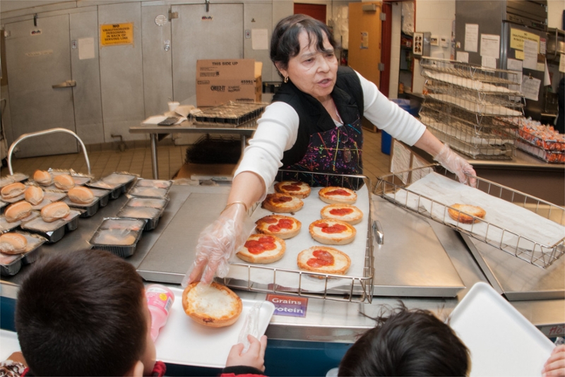 lunch lady distributing pizza 