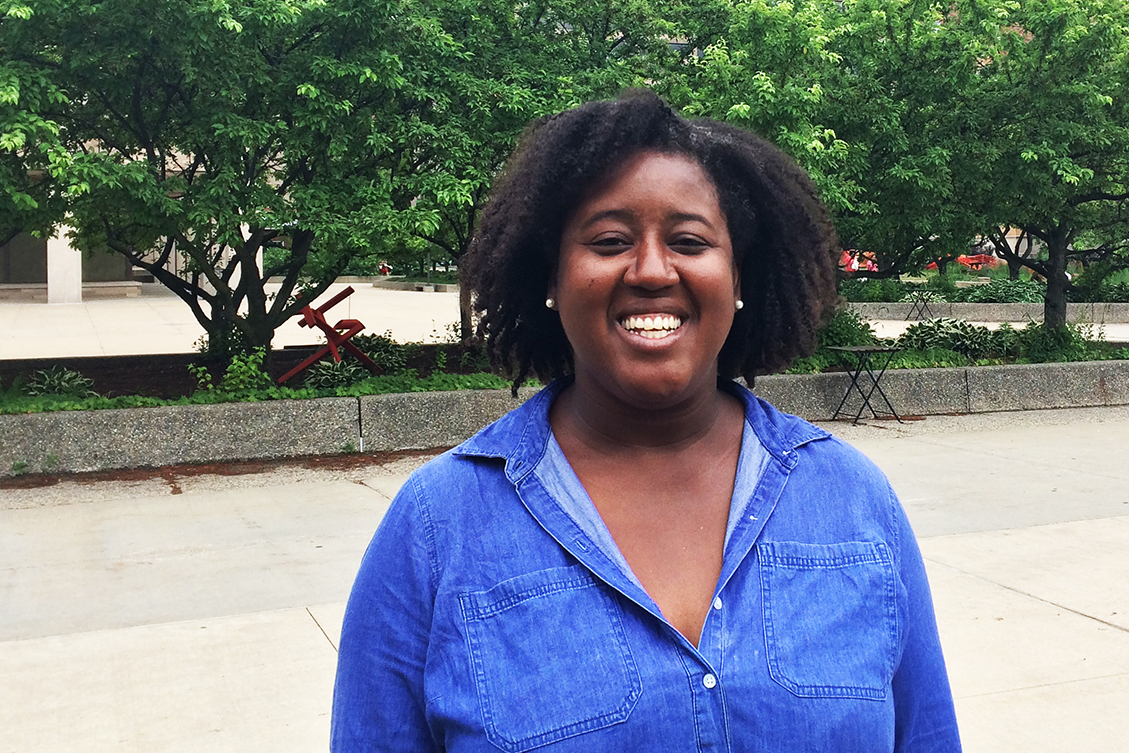 Head and shoulders shot of Suzanne Babb, smiling and standing outside in a blue shirt..