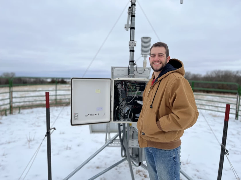 Kerkman in front of one of the weather stations he services 