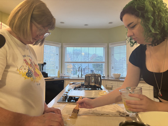 Ana Veros and her mom Wendy spread butter on the pastry dough