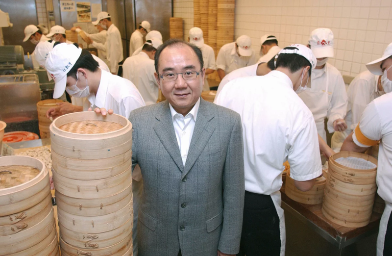 Yang Ji-Hua with a pile of bamboo steamers 