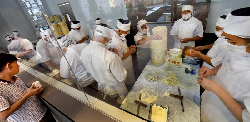 Employee making dumplings