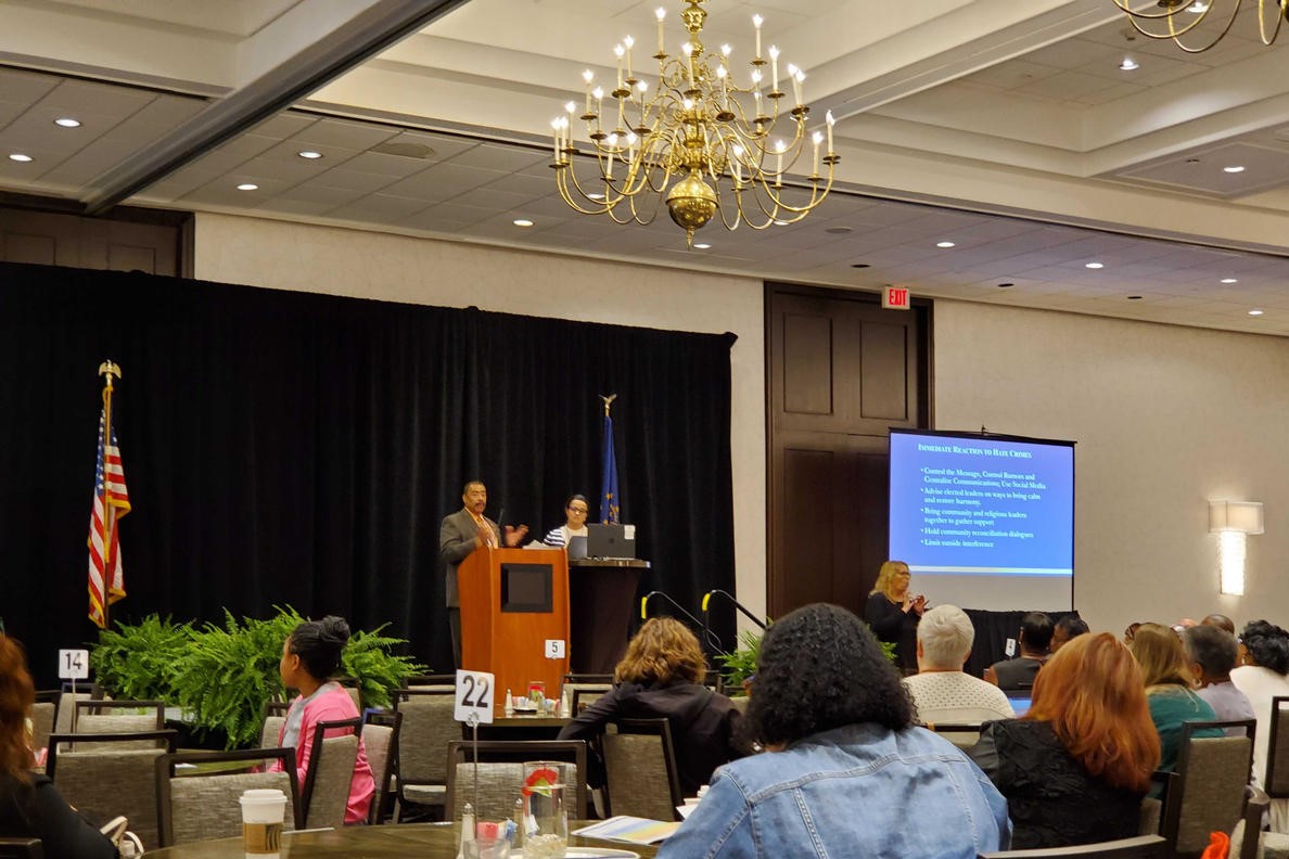 Department of Justice specialist Ken Bergeron and Women4Change Indiana executive director Rima Shahid address an Indiana Civil Rights Commission Conference.