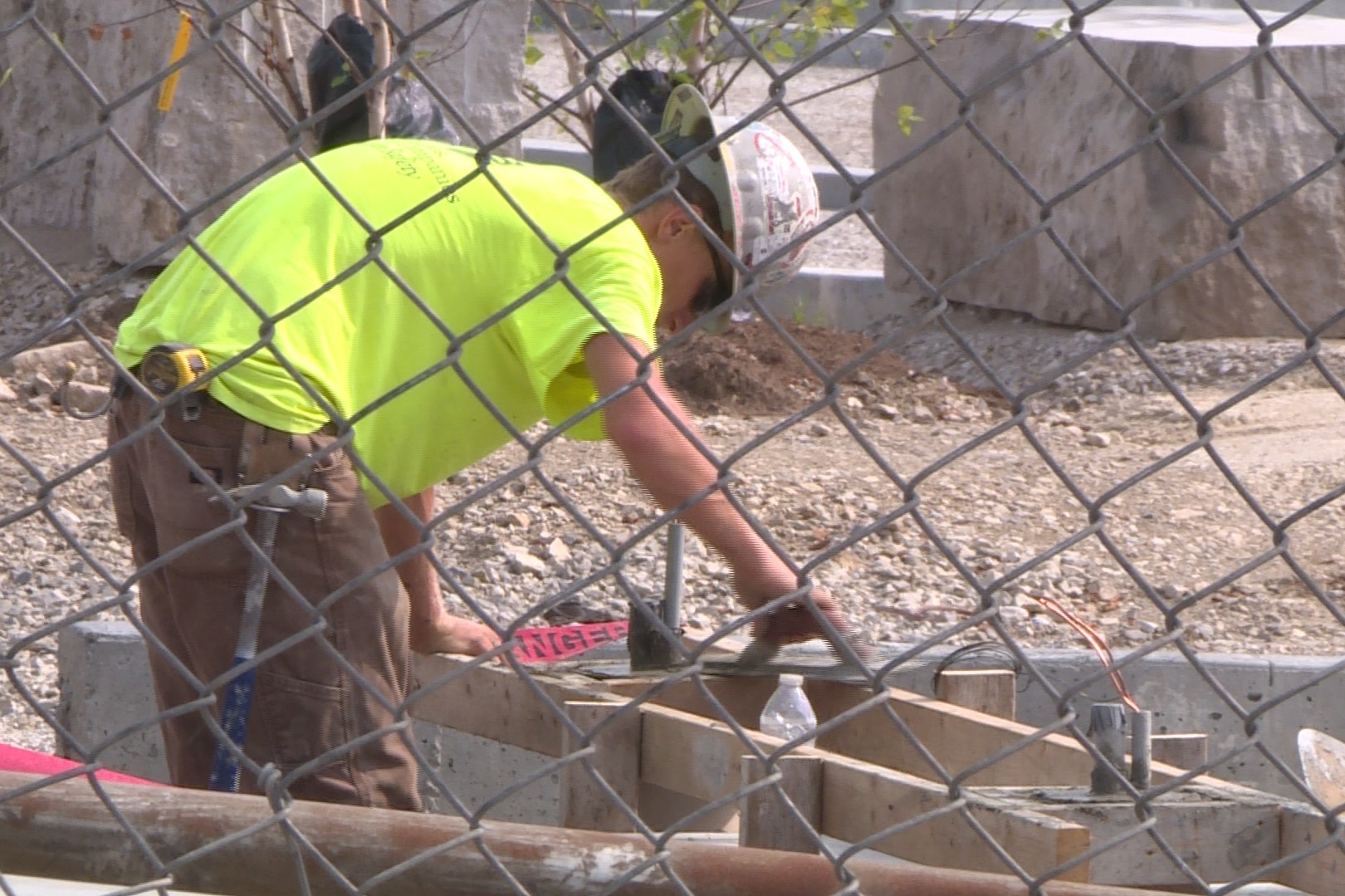 A man works construction on the future site of Switchyard Park on South Rogers Street.