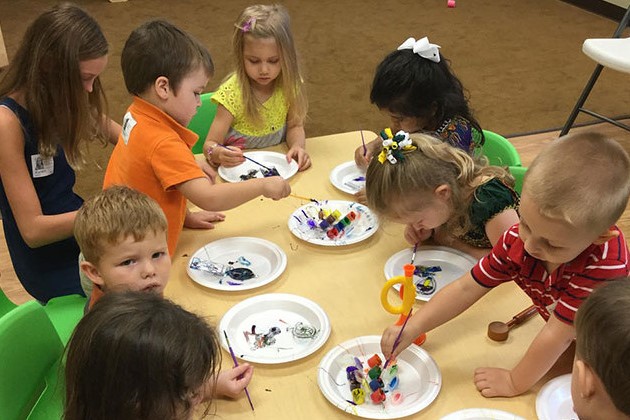 A stock photo of preschoolers painting.