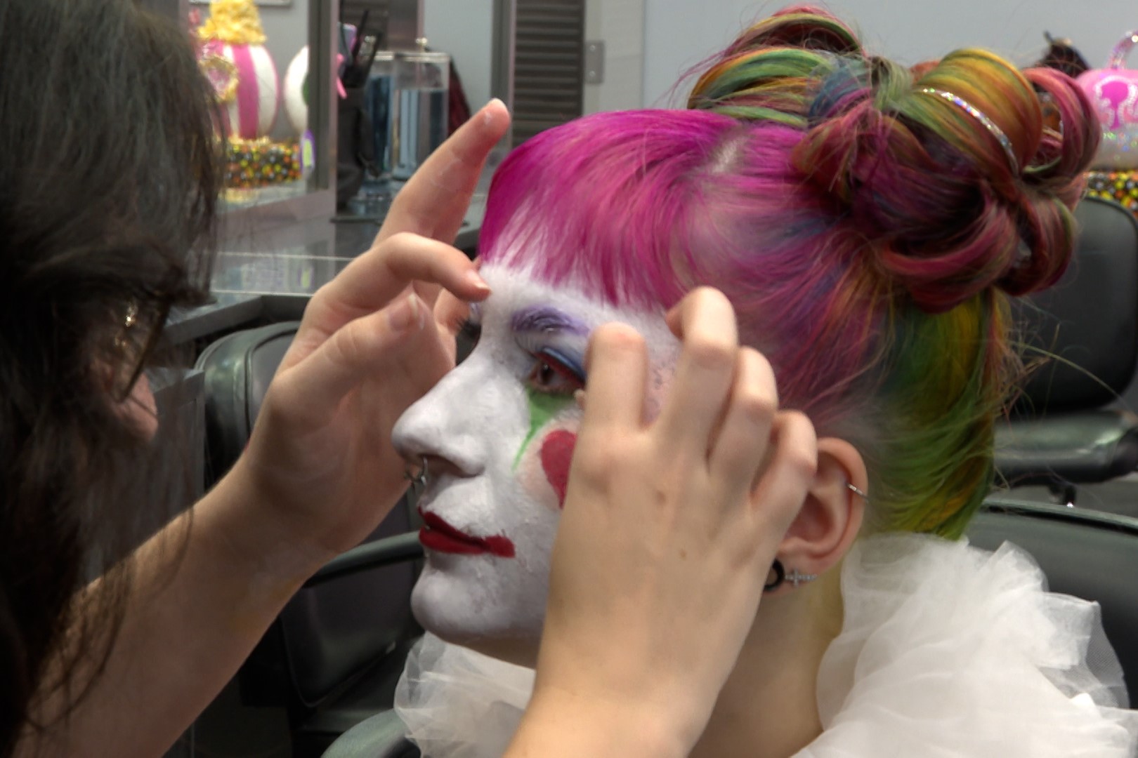 Esthetician student Allie Phillips applies false lashes on cosmetologist student Erin McGreevy.