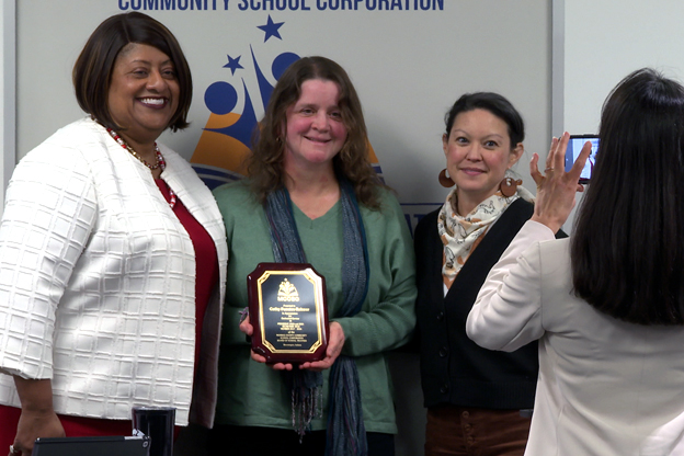 Cathy Fuentes-Rohwer receives a plaque for her service after serving her last meeting.