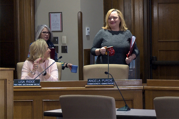 Amanda Barge walks in the commissioners meeting
