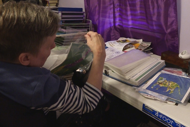 Bonnie Hasemeyer looks at some of her artwork at her home in Indianapolis