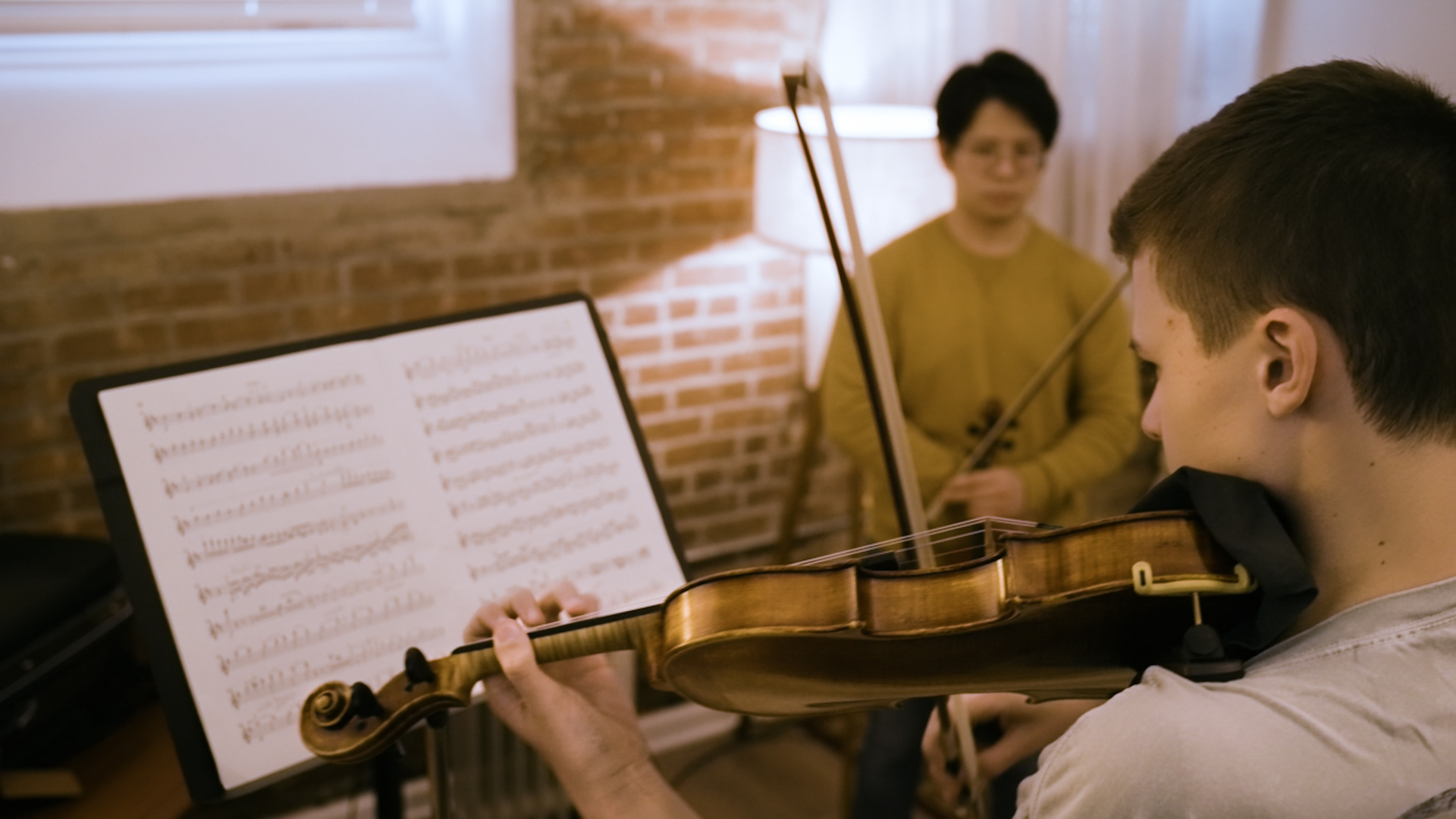 Braden Riley works under the tutelage of Michael Chu, principal second violinist for the Evansville Philharmonic Orchestra. (Tim Jagielo / WNIN Video Still)