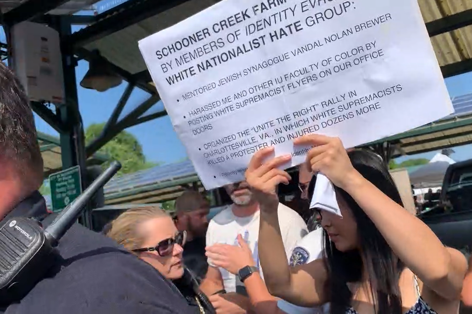 Cara Caddoo protests at the Bloomington Farmer's Market. July 27 2019.