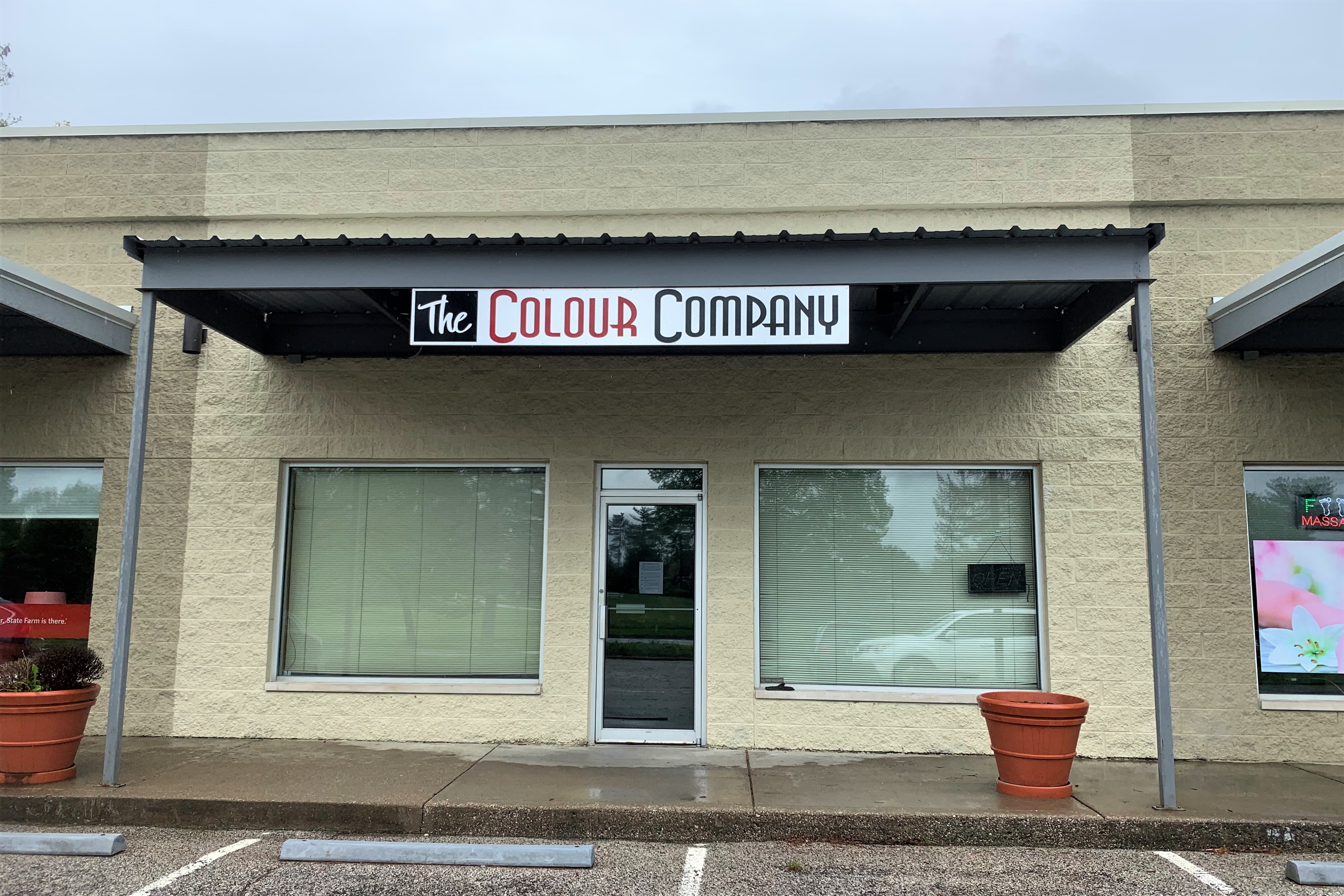 AN exterior shot of The Color Company, a hair salon.