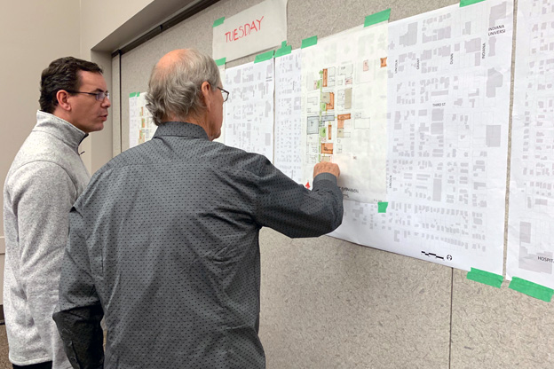 Residents look at wall sketches