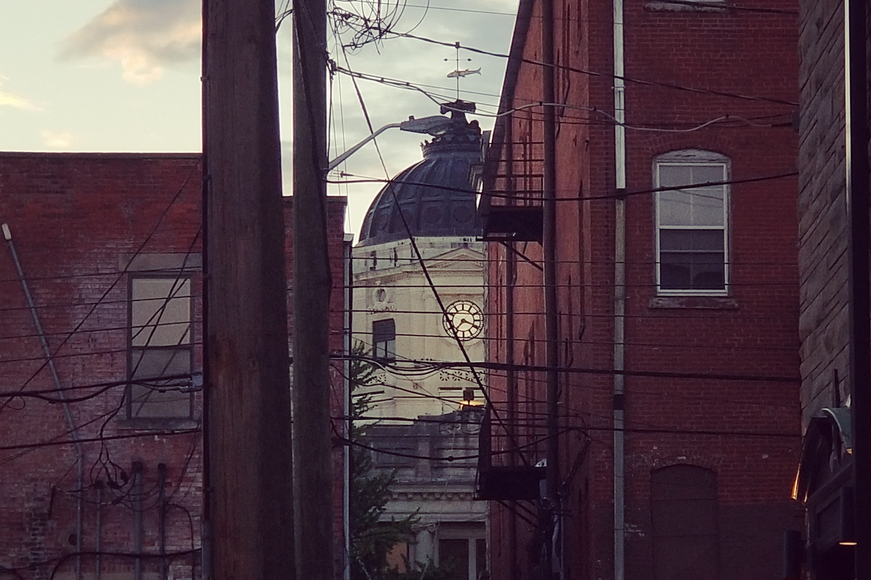 The dome of the old Bloomington courthouse shot through some buildings downtown.