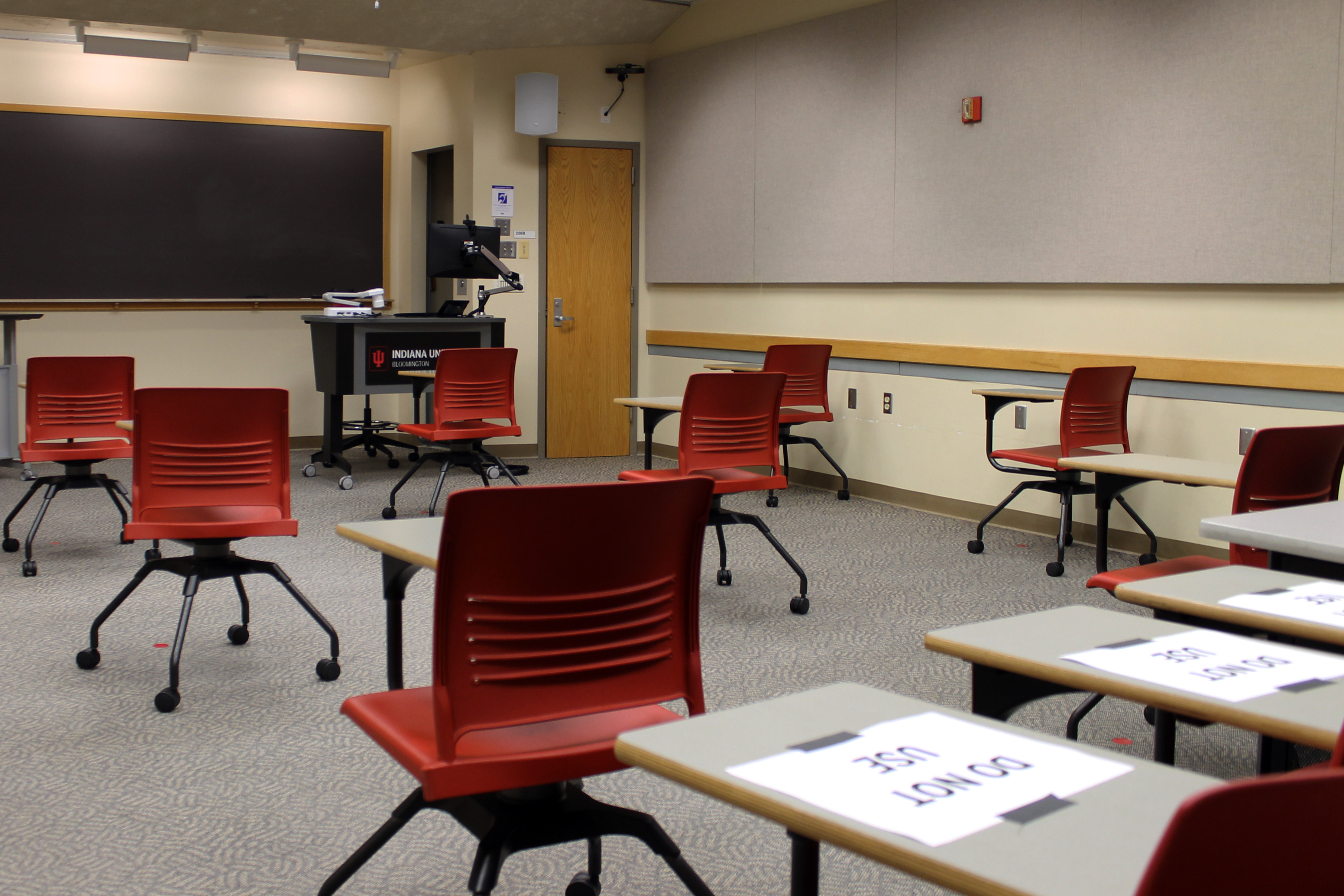 Worker stands at a COVID-19 testing center at IU Bloomington on Sunday, Aug. 9, 2020.