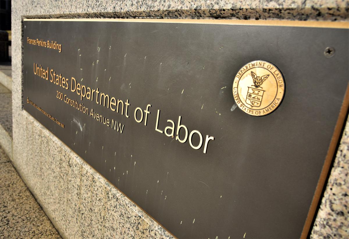 A placard in front of the U.S. Department of Labor. A proposed mandate would have Occupational Safety and Health Administration enforce a requirement that businesses with 100 or more employees be vaccinated or get tested weekly. 