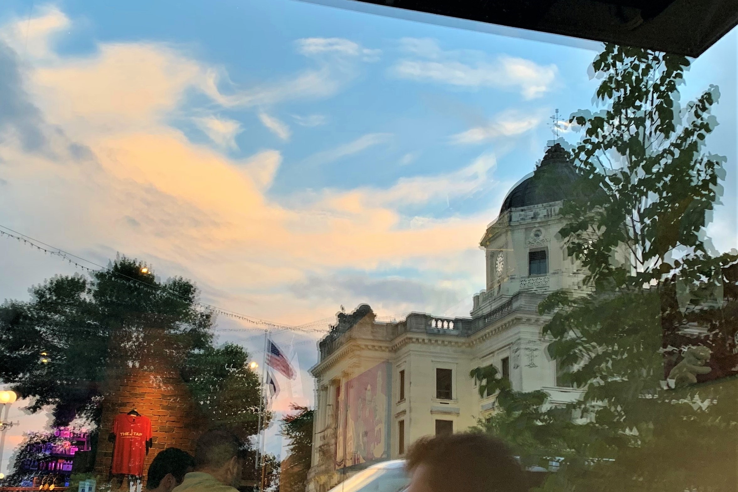 File: A reflection of the Monroe County Courthouse in the window of a downtown Bloomington business.