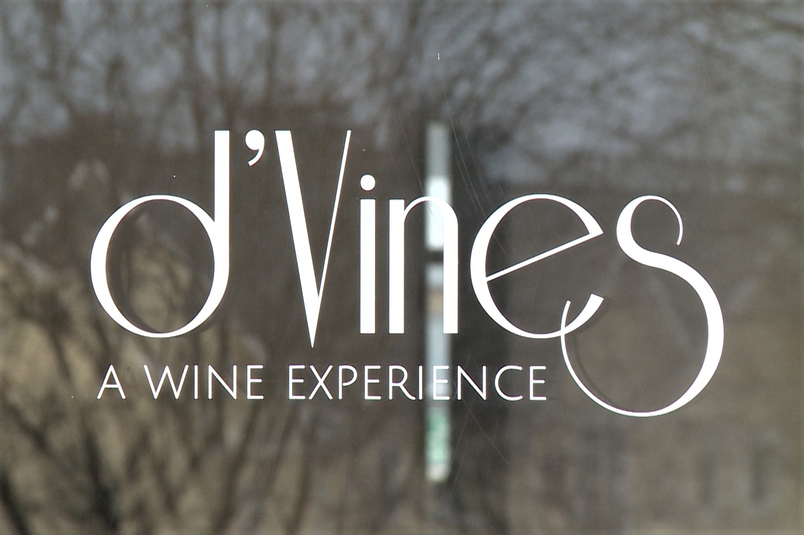 The door sign for d'Vines: A Wine Experience in Bloomington.