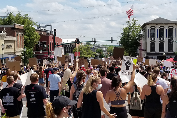 Protesters at June 5's "Enough is Enough" demonstration walk down Walnut St in Bloomington.